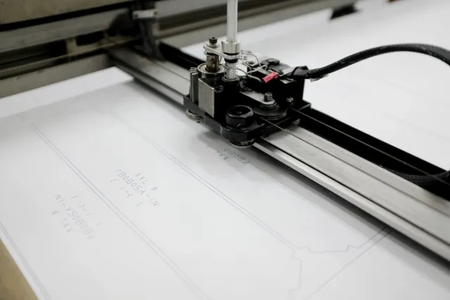 Plotter drawing pattern pieces on marker paper