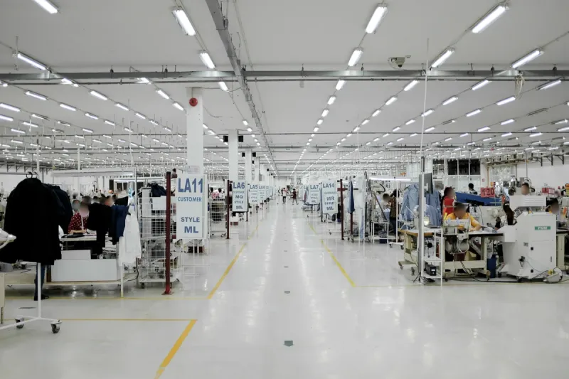 Long, bright sewing floor with production lines on both sides