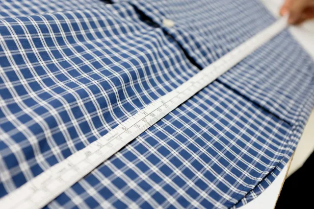 Blue and white check shirt measured with a tape